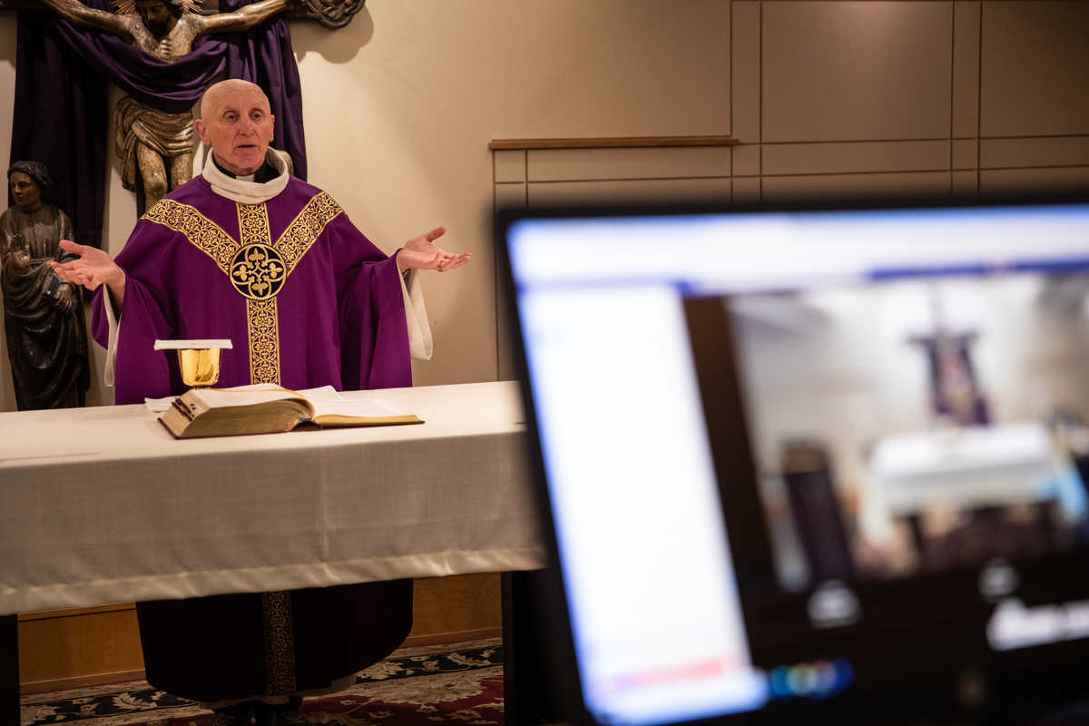 Father Lawrence Blake, chaplain and director of Campus Ministry, conducts an online virtual mass from Florence Chapel in the basement of Aquinas Chapel in St. Paul in 2020. Campus Ministry is adapting Ash Wednesday mass to accommodate social distancing due to the coronavirus pandemic. (Mark Brown/University of St. Thomas)