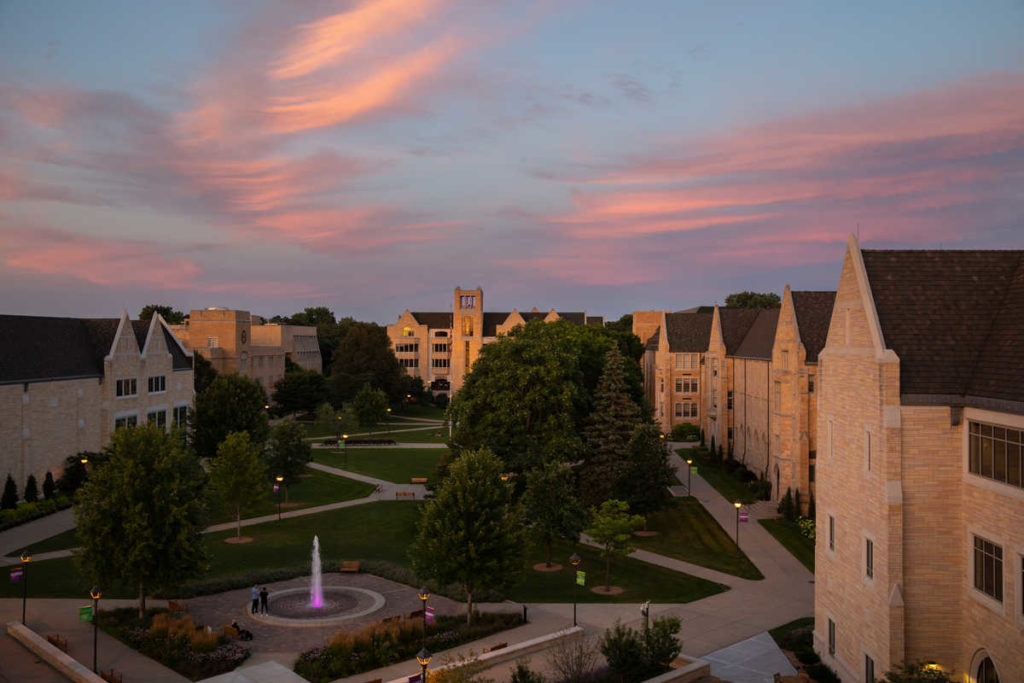 The lower quad, Monahan Plaza, Aquinas Hall and the O'Shaughnessy-Frey Library are pictured under glowing pink skies on a beautiful summer night on July 29, 2020, in St. Paul.
