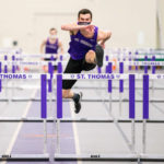 Evan Tenor leaps over hurdles during an indoor track meet in the Field House. Liam James Doyle/University of St. Thomas