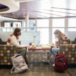 Freshmen Sam Lang, left, and Alivia Riemenapp tackle school work in the Anderson Student Center. Liam James Doyle/University of St. Thomas