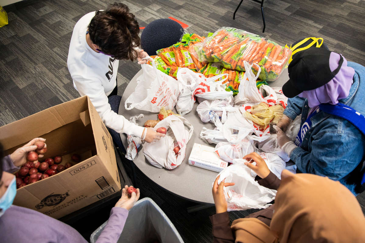 Student volunteers work to organize and fill bags of food items in Opus Hall where Tommie Shelf expanded it’s efforts and launched on the Minneapolis campus on March 17, 2021.