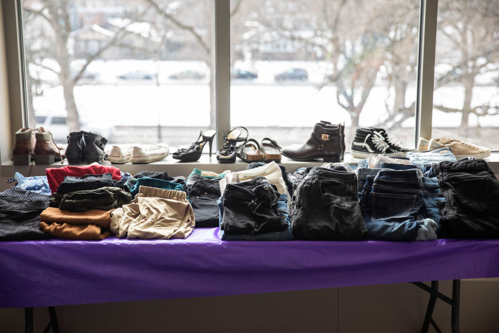 Donated clothing sits on a table at Tommie's Closet. Mark Brown/University of St. Thomas