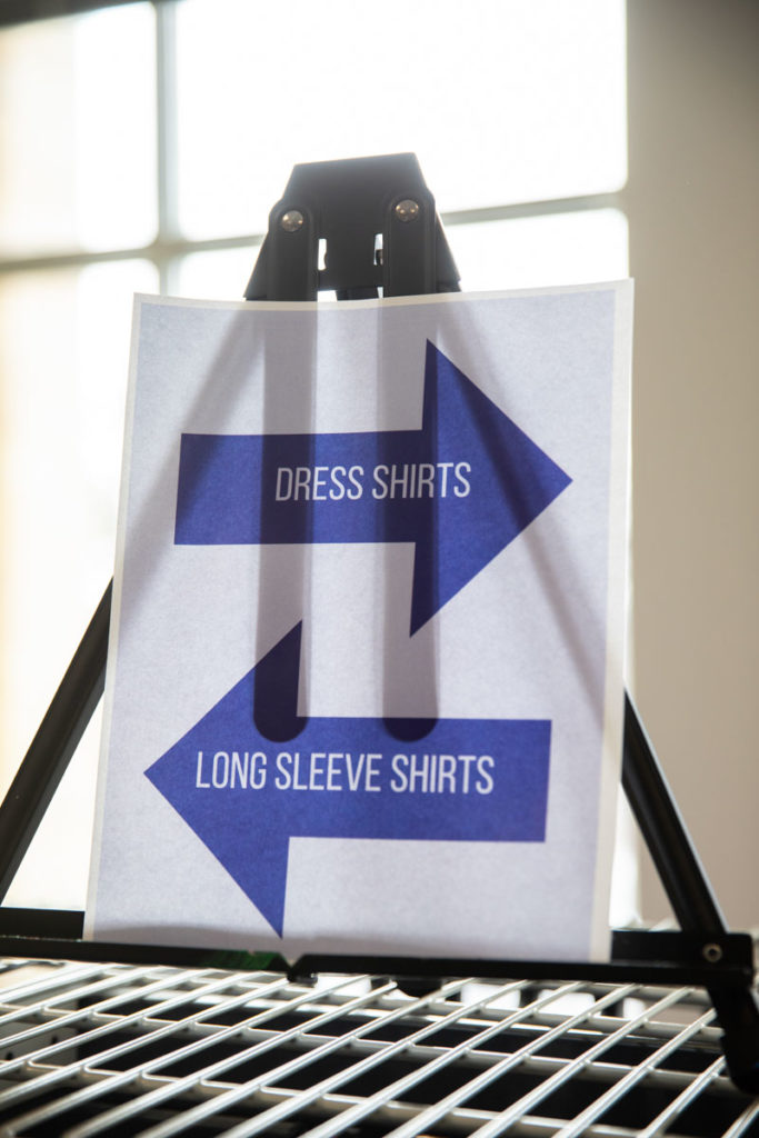 A sign stands on a rack at Tommie's Closet in the Anderson Student Center. Mark Brown/University of St. Thomas