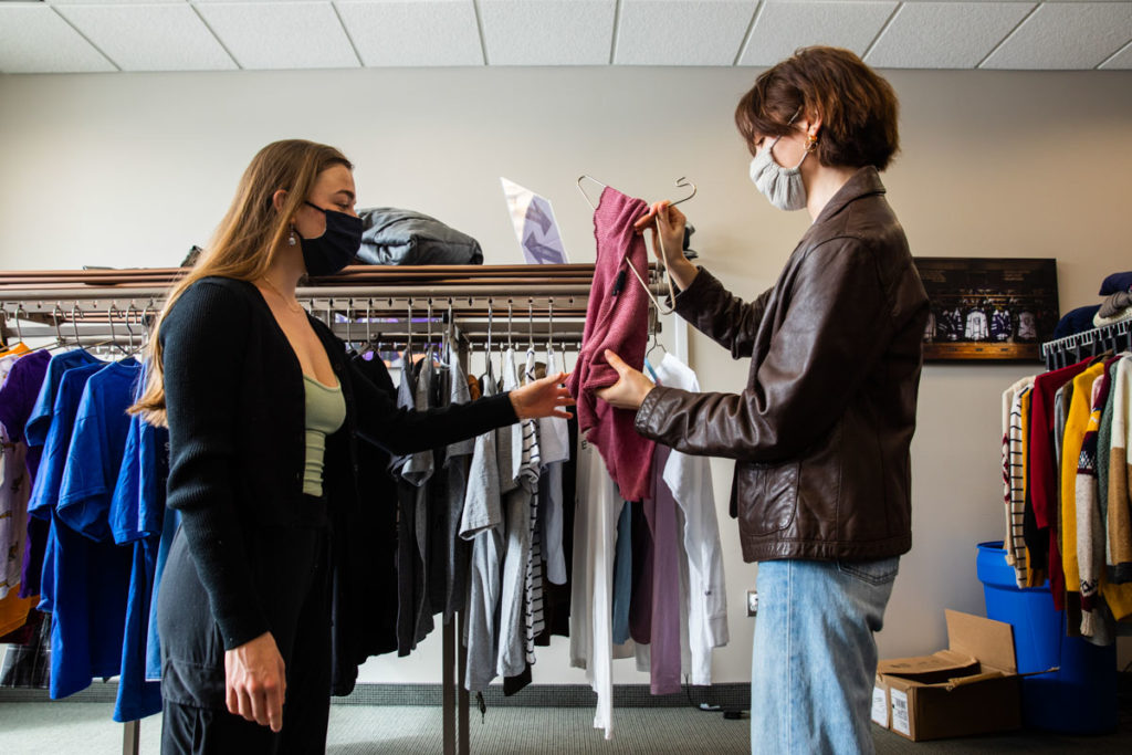 Co-founder Payton Filipiak, right, and volunteer Grace McAlees-Callanan look at clothes at Tommie's Closet. Mark Brown/University of St. Thomas