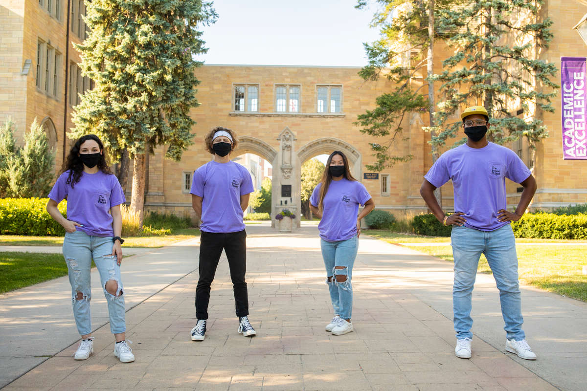 Students wearing The Impact Project T-shirts in front of the Arches.