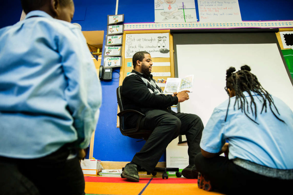 First grade teacher Al McCoy '10 (Education) reads to his students at Prodeo Academy public charter school in Columbia Heights, MN, on December 5, 2016. The school has strong St. Thomas alumni connections and support.
