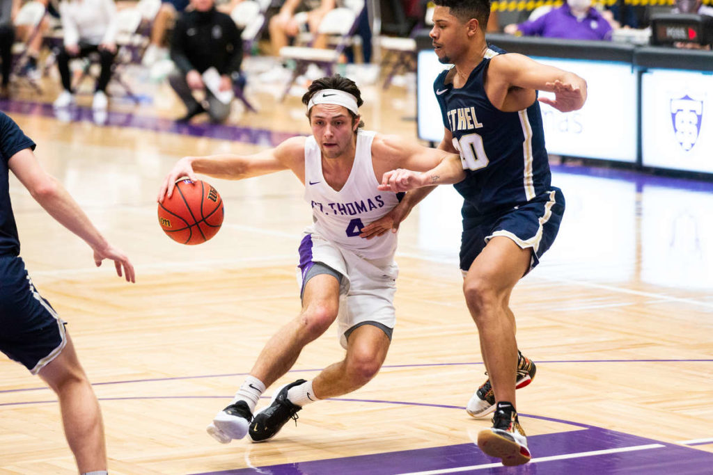 Anders Nelson pushes toward the net on March 6, 2021 at Schoenecker Arena in St. Paul where the University of St. Thomas men's basketball team defeated Bethel with a final score of 84-66. Liam James Doyle/University of St. Thomas