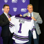 Rico Blasi is given his own University of St. Thomas hockey jersey by director of athletics Phil Esten during a press conference in the James B. Woulfe Alumni Hall on April 6, 2021 in St. Paul. Blasi will become the University’s first Division-I hockey coach. Liam James Doyle/University of St. Thomas