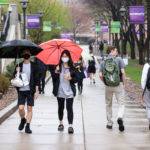 Students walk across campus on a rainy spring day. Mark Brown/University of St. Thomas