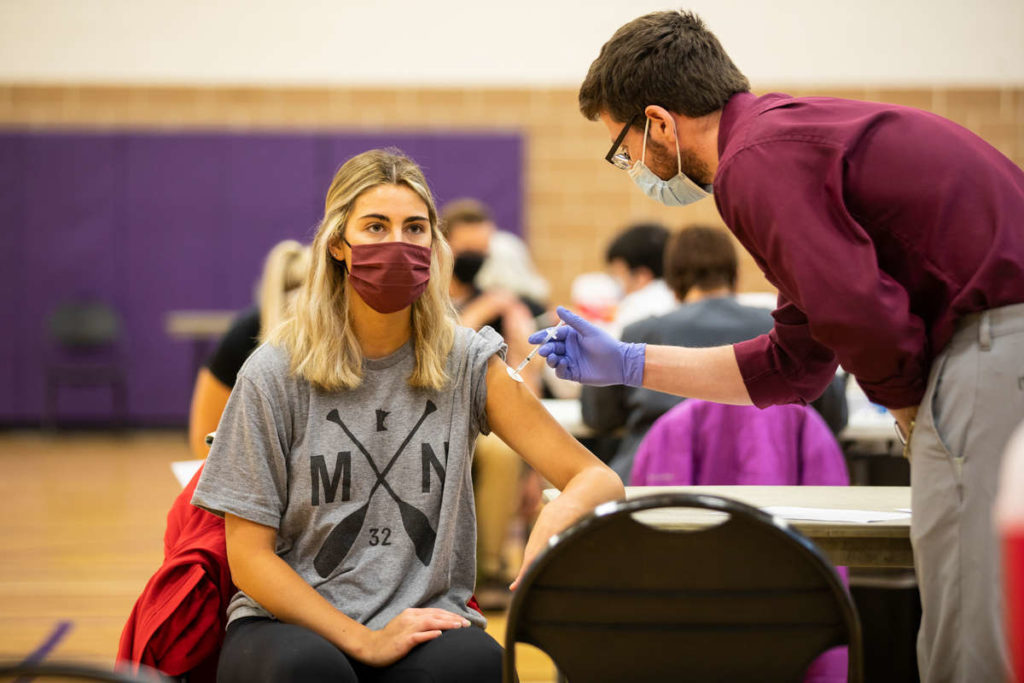 Korbyn Perpich receives the COVID-19 vaccine in the McCarthy Gym. Liam James Doyle/University of St. Thomas