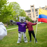 An international Freshman student takes a photo with Tommie.