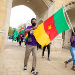 International Freshman students carry their respective country’s flags.