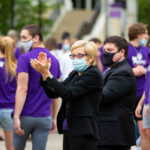 President Julie Sullivan cheers for freshman students during the annual March through the Arches.
