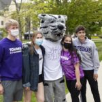 Students pose for a photo with Tommie during Tommie Fest. Mark Brown/University of St. Thomas