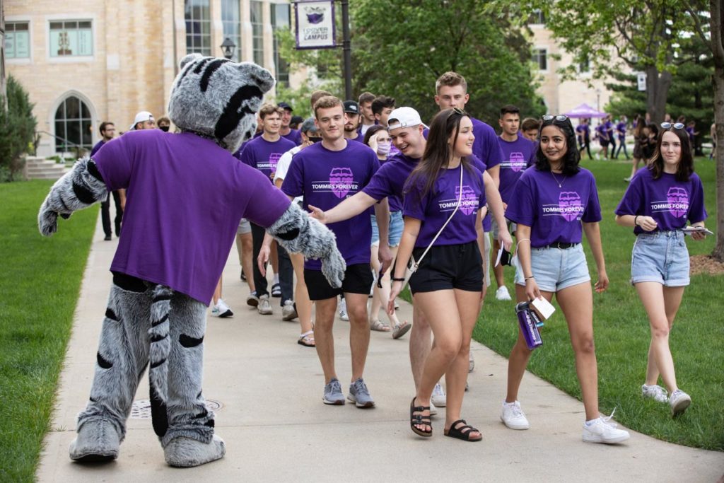 Students greet Tommie the mascot as they walk through the lower quad toward the annual March Out of the Arches event. Mark Brown/University of St. Thomas