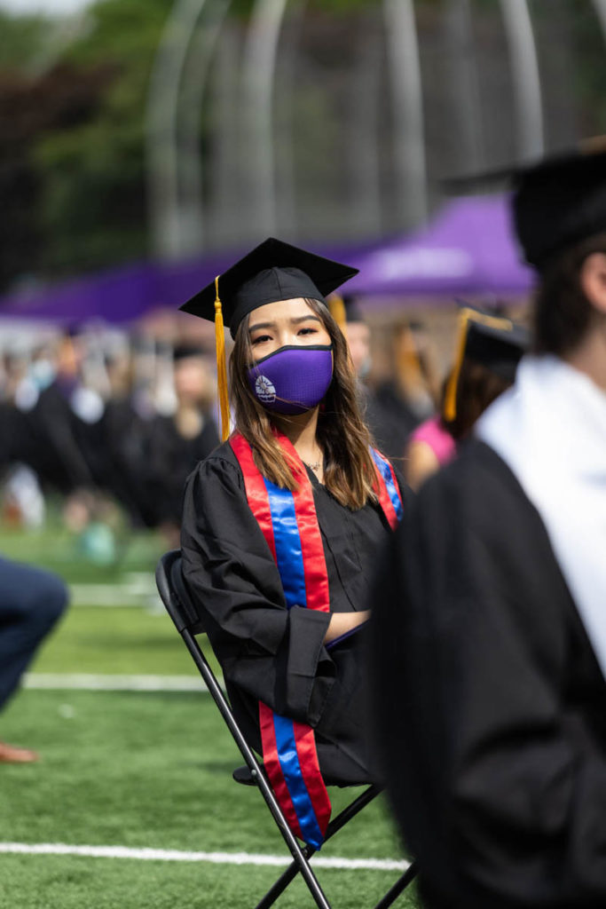 A student listens to a speech during the College of Arts and Sciences commencement ceremony. Mark Brown/University of St. Thomas