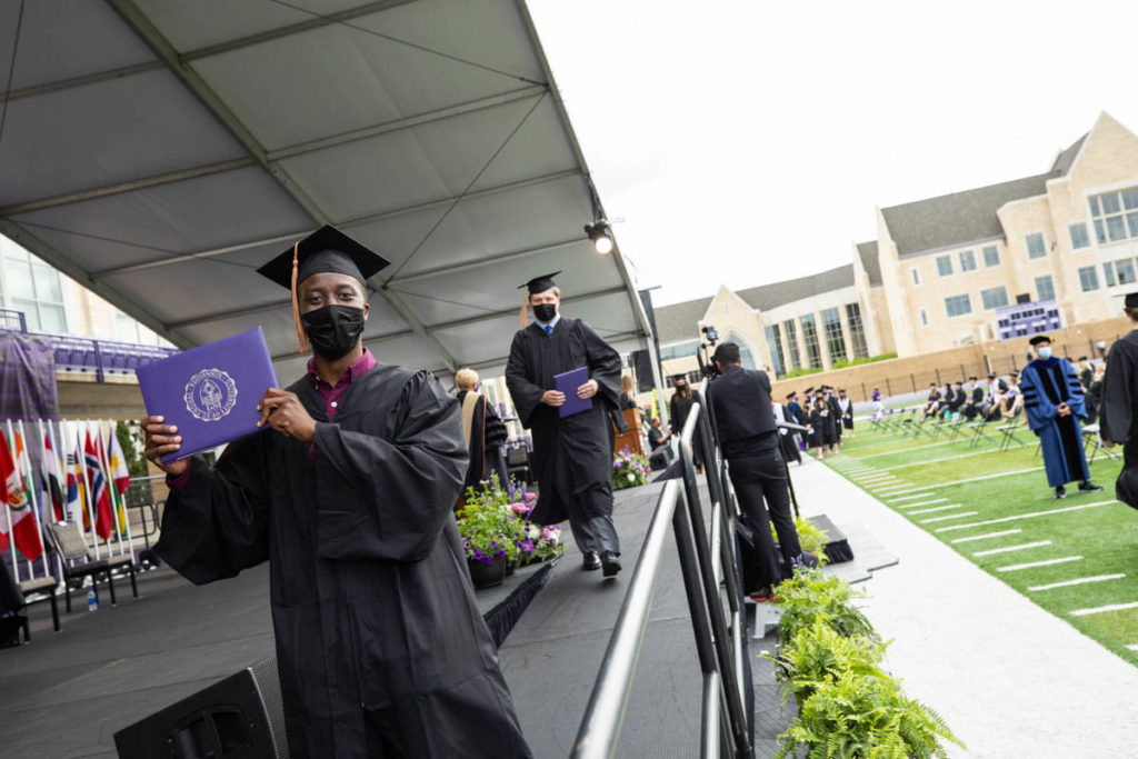 Shukrani Nangwala receives his diploma during the Opus College of Business undergraduate commencement ceremony. Mark Brown/University of St. Thomas