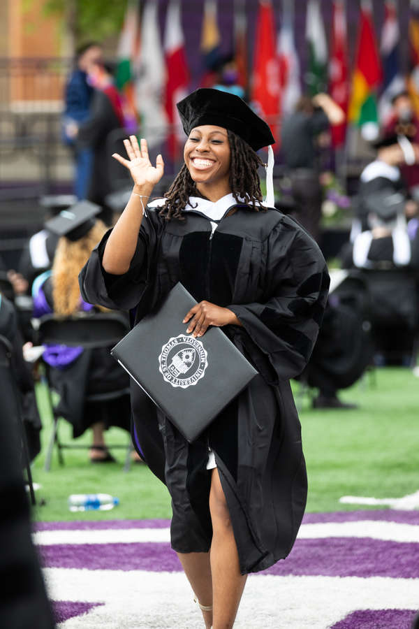A student walks back to her seat after receiving her diploma at the commencement ceremony for graduate programs. Mark Brown/University of St. Thomas