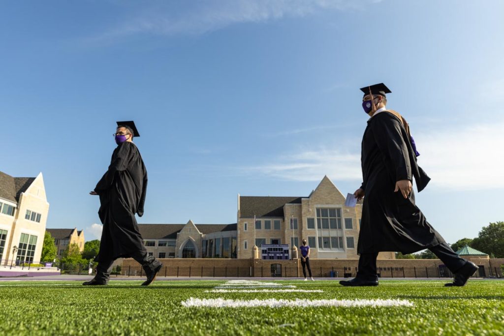 Students walk toward the stage during the commencement ceremony for graduate programs in the Opus College of Business and School of Engineering. Mark Brown/University of St. Thomas