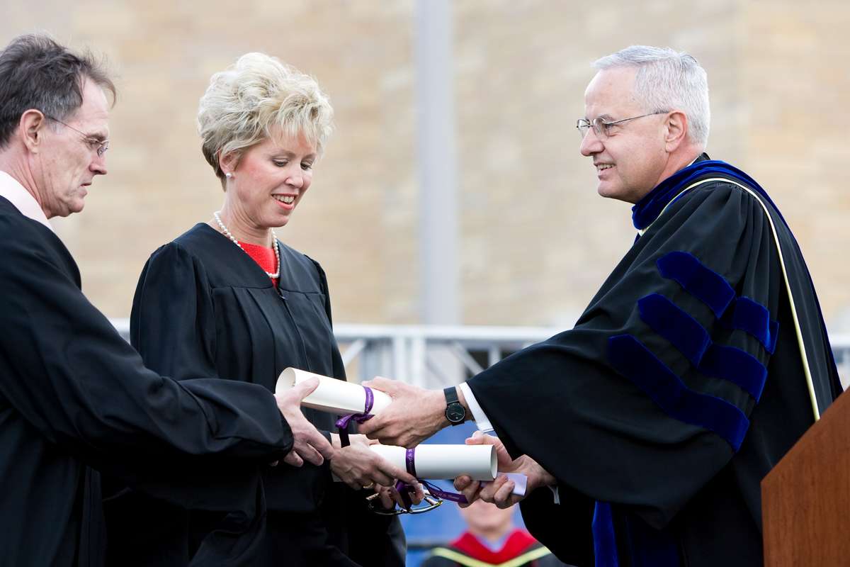 President Dennis Dease presents Dennis and Megan Doyle honorary degrees.