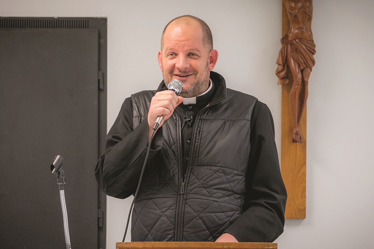 Father Byron Hagan speaking at an event.