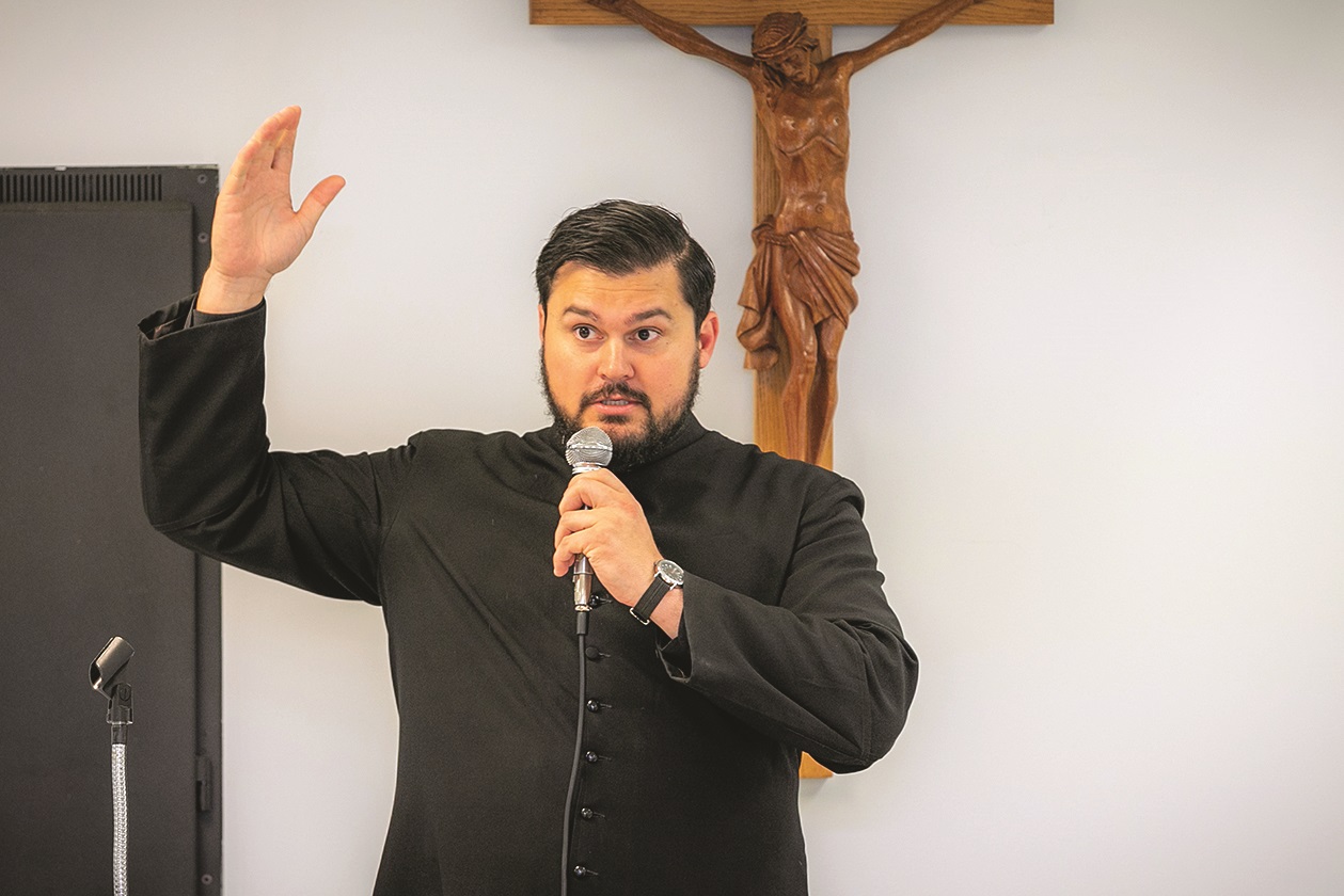 Father Spencer Howe talking at an event.