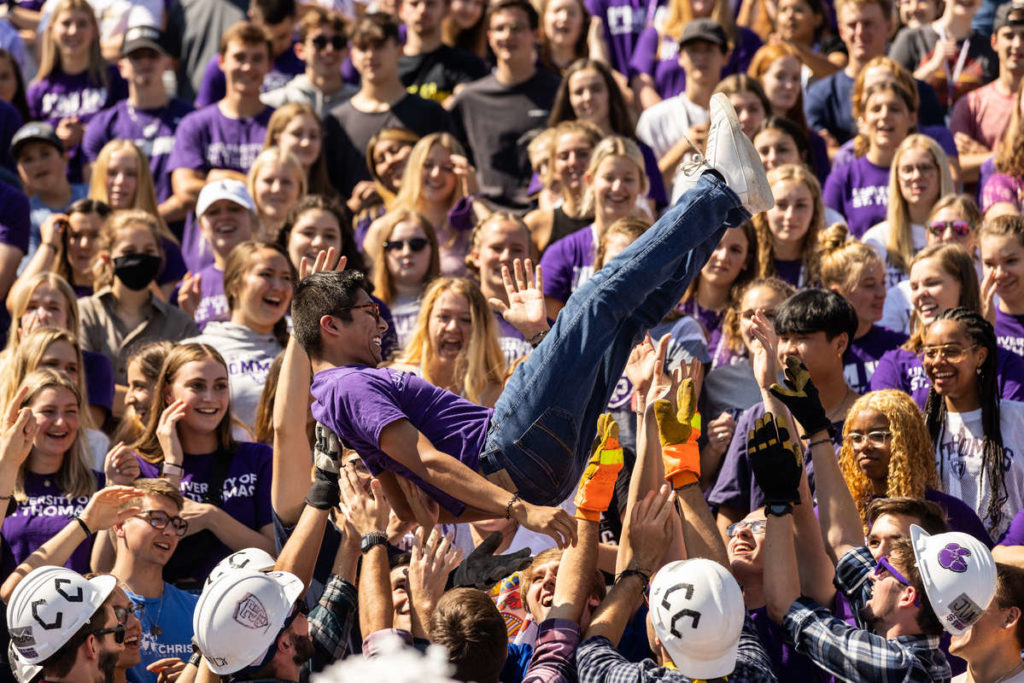 Members of Caruso’s Crew toss a fan to celebrate a touchdown during the Roll Toms Fan Fest in O’Shaughnessy Stadium on September 4, 2021, in St. Paul.