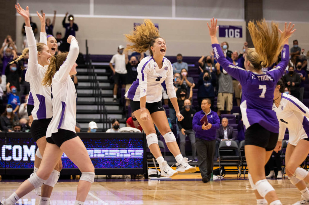 The University of St. Thomas Women’s Volleyball Team celebrates their match-winning point at Schoenecker Arena on September 30, 2021, in St. Paul during their first Division 1 home game. Liam James Doyle/University of St. Thomas