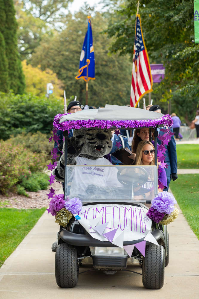 Tommie waves from his Golf Cart leading the Homecoming Parade. Liam James Doyle/University of St. Thomas