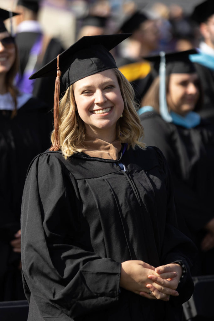 Krista Palmquist smiles during a commencement ceremony.