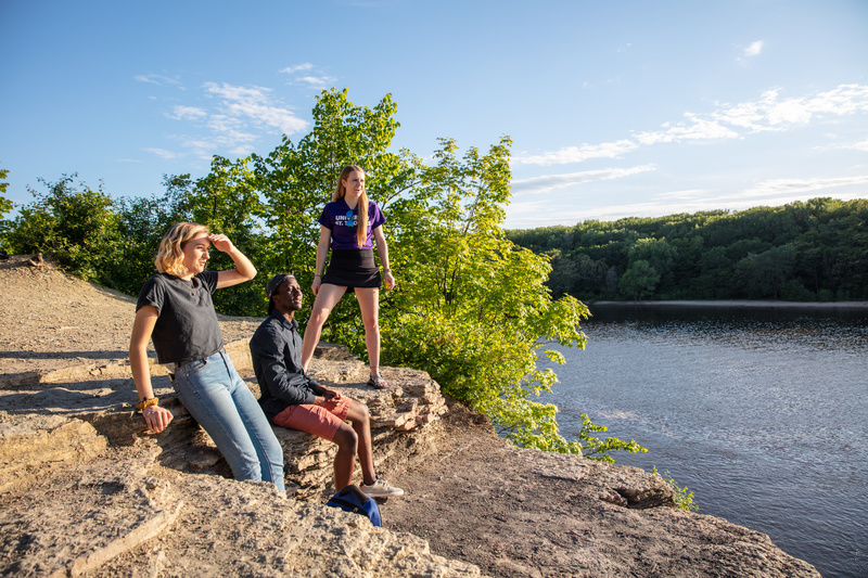Students Sarah Benoy, Shukrani Nangwala and Mackenzie Stahl talk on the river bluffs overlooking the Mississippi River in Shadow Falls Park in St. Paul on June 13, 2019.