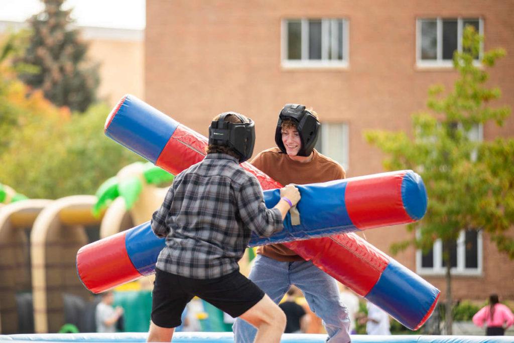 Students play giant inflatable games on the upper quad as a part of Homecoming Weekend activities. Liam James Doyle/University of St. Thomas