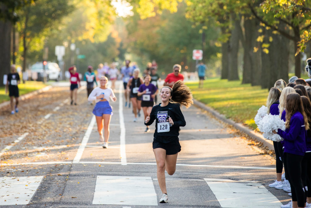 Runners head down Summit Avenue during the Wellness 5k hosted by the Center for Well-Being as a part of Homecoming weekend events on October 9, 2021, in St. Paul.