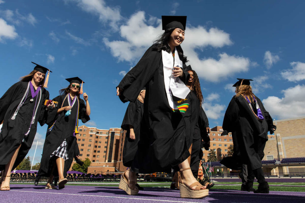 Graduates walk out of Palmer Field during a commencement ceremony in O’Shaughnessy Stadium on October 10, 2021, in St. Paul. The graduation ceremony was finally celebrated after being canceled in 2020 due to the COVID-19 pandemic. Mark Brown/University of St. Thomas