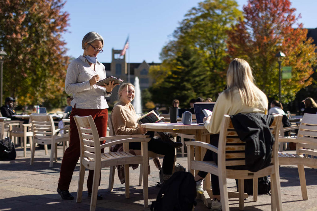 Theology Professor Cara Anthony teaches a class on Monahan Plaza. Mark Brown/University of St. Thomas
