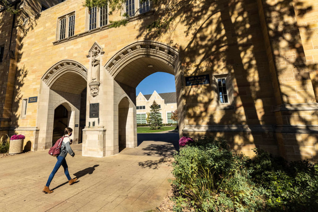 A student walks through the Arches on a beautiful fall day. Mark Brown/University of St. Thomas
