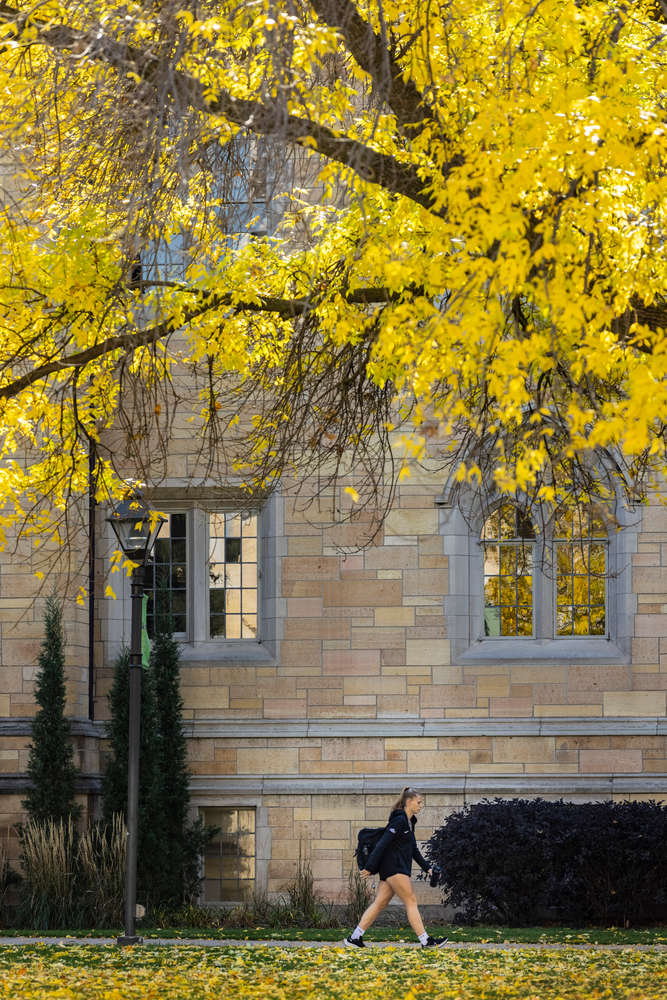 A student walks past Aquinas Hall on a beautiful fall day. Mark Brown/University of St. Thomas