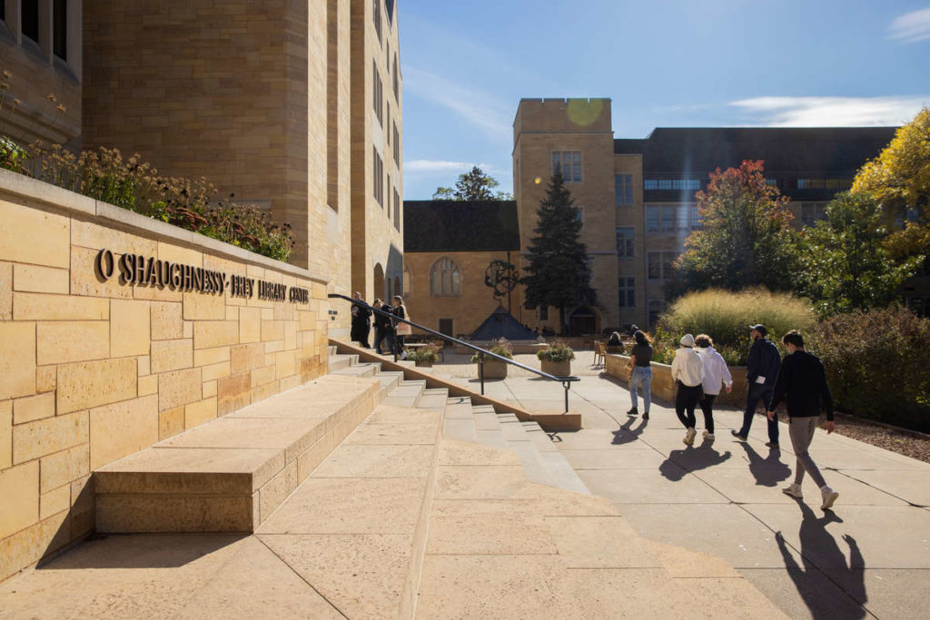 A guided campus tour passes by the front steps of the O’Shaugnessy-Frey Library Center. Liam James Doyle/University of St. Thomas