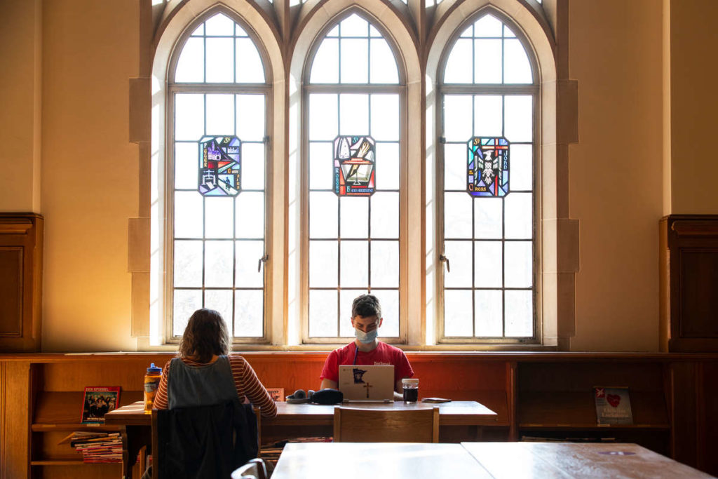 John Paul Bean (Psychology) and Katy Shimp (Spanish and Catholic Studies) do homework in the O'Shaughnessy-Frey Library Center in March. Mark Brown/University of St. Thomas