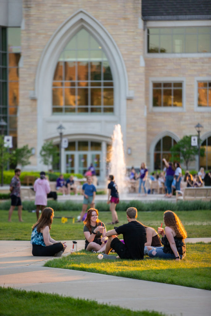 Students socialize and lounge on the lawn of the lower quad. Liam James Doyle/University of St. Thomas
