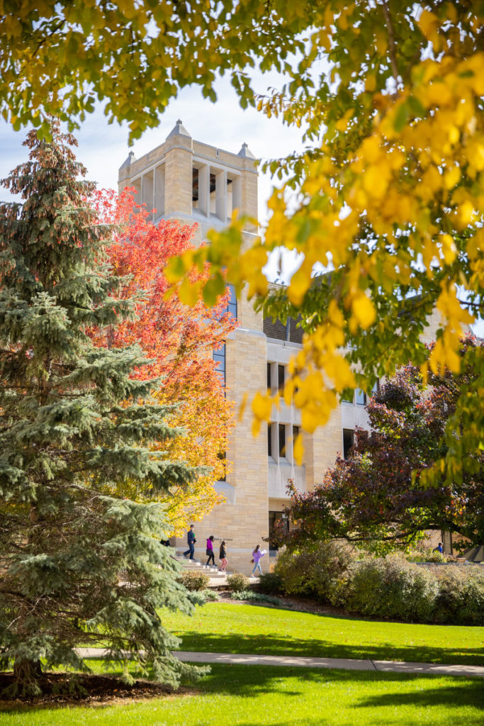 A guided campus tour passes by the front steps of the O’Shaugnessy-Frey Library Center in autumn. Liam James Doyle/University of St. Thomas