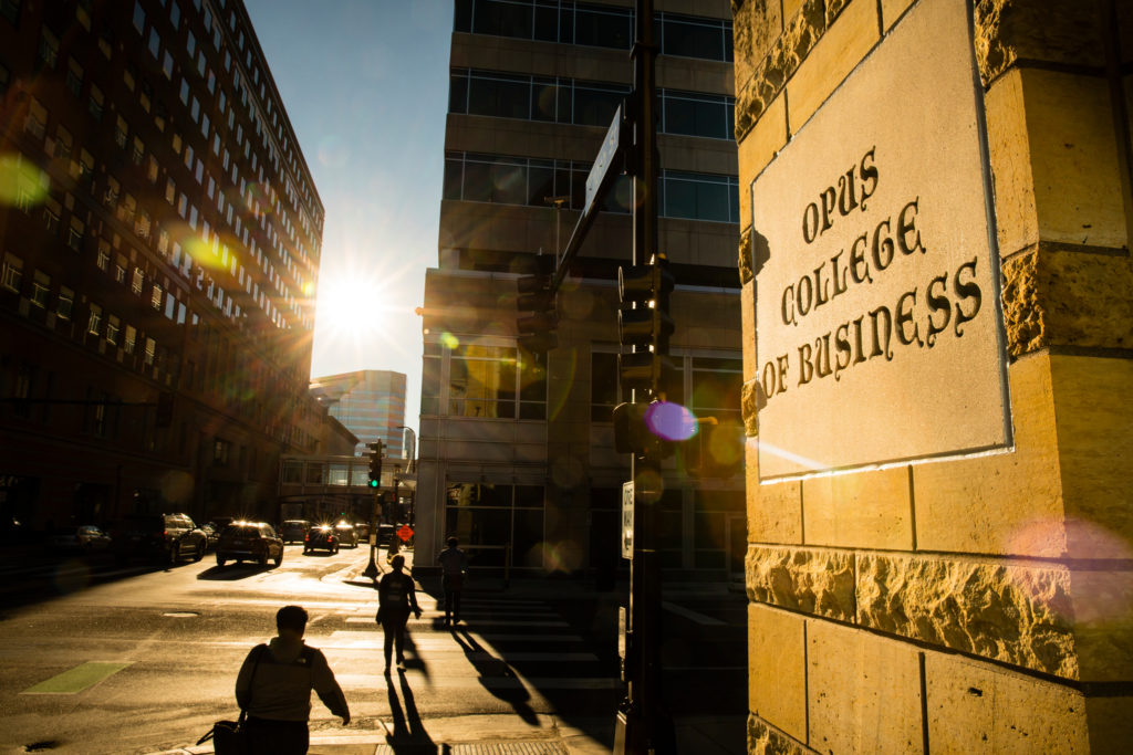 The sun shines on a sign for Opus College of Business on Terrence Murphy Hall in Minneapolis on October 4, 2017.