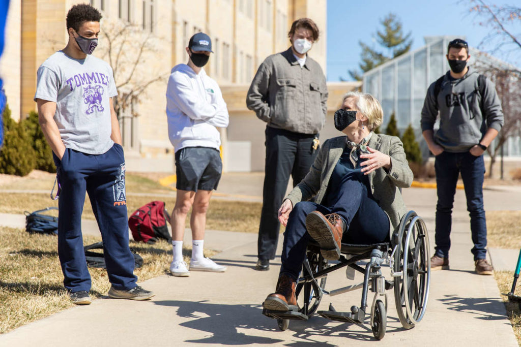 Dr. Jenny Holte in a wheelchair with students.