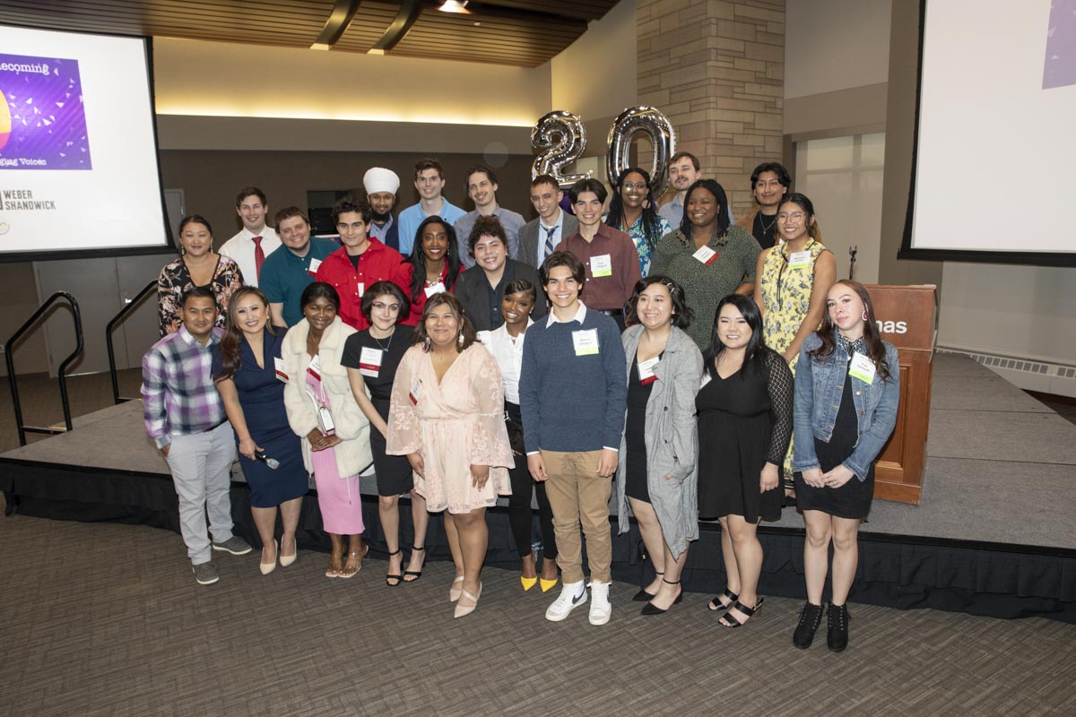 Program alums pose for a group photo at the ThreeSixty Journalism Homecoming 20th Anniversary Celebration in Woulfe Alumni Hall in St. Paul on April 9, 2022.
