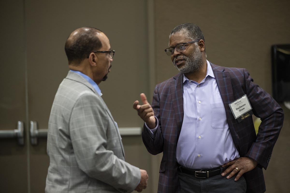 Duschesne Drew, president of Minnesota Public Radio and a program Board Member, talks with a guest at the ThreeSixty Journalism Homecoming 20th Anniversary Celebration in Woulfe Alumni Hall in St. Paul on April 9, 2022.