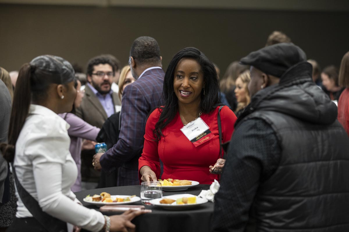 An alum socializes at the ThreeSixty Journalism Homecoming 20th Anniversary Celebration in Woulfe Alumni Hall in St. Paul on April 9, 2022.
