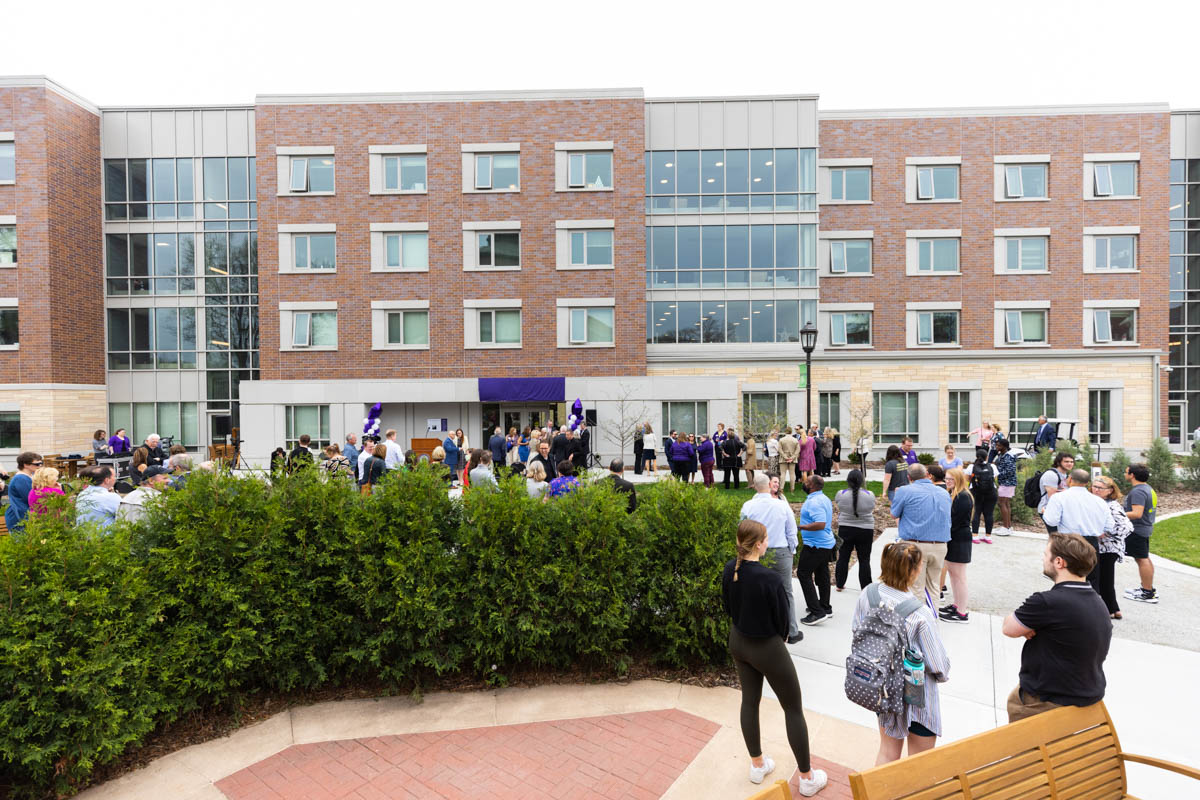 Attendees gather for an event celebrating the Frey Room and Board Grants gift in front of the newly renamed Mary and Gene Frey Hall (formerly Tommie East) on May 11, 2022 in St. Paul.