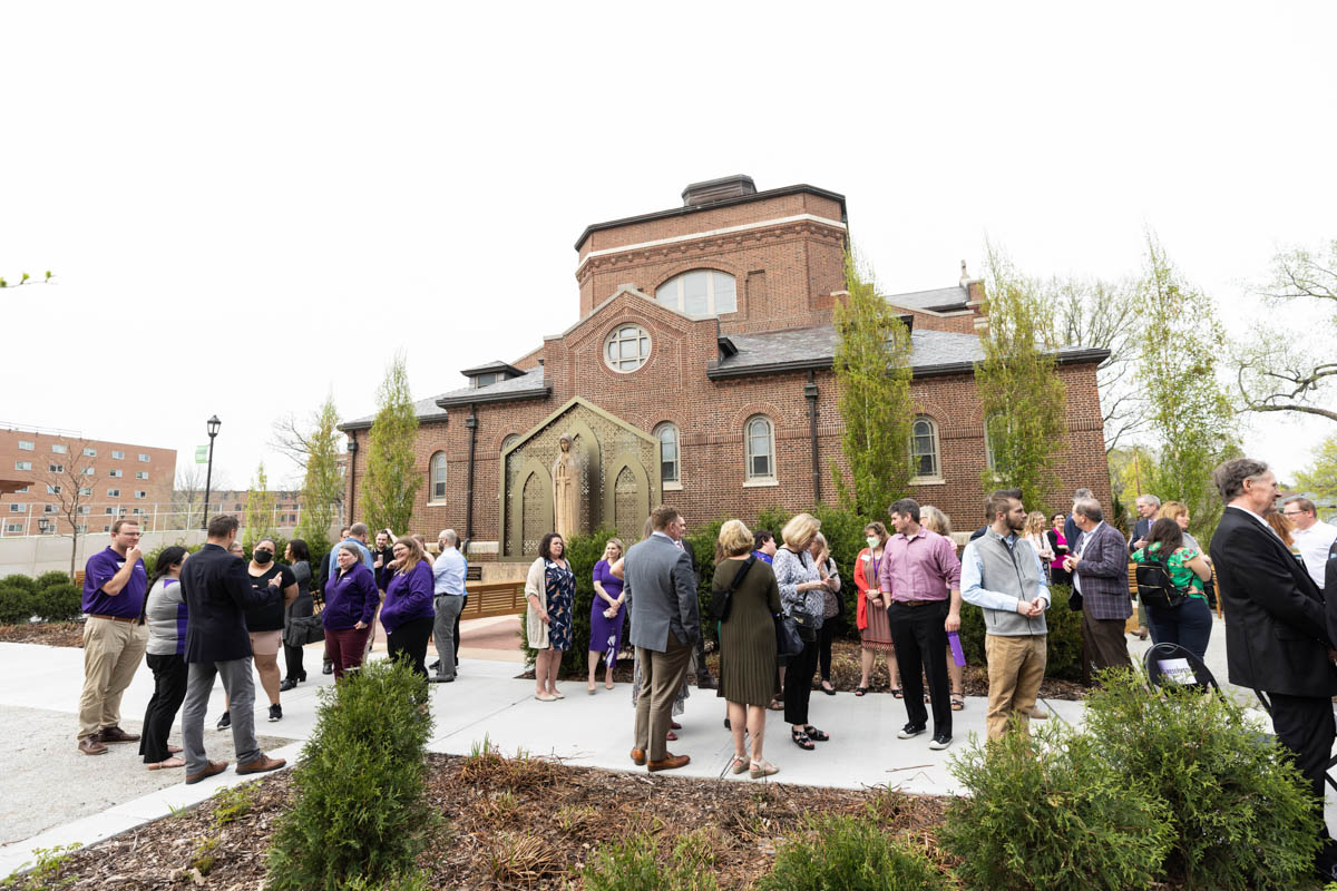 Attendees gather during an event celebrating the Frey Room and Board Grants gift in front of the newly renamed Mary and Gene Frey Hall (formerly Tommie East) on May 11, 2022 in St. Paul.