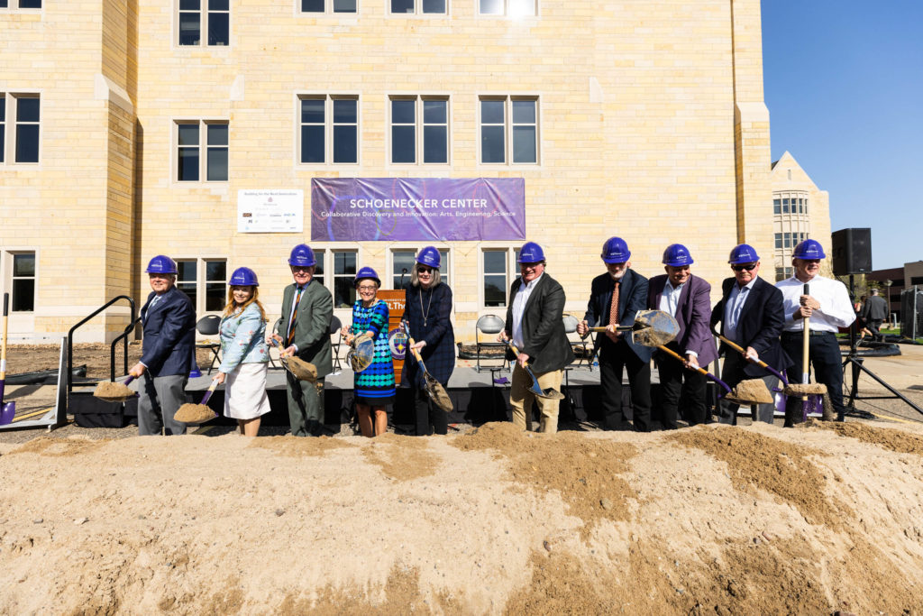President Julie Sullivan, donors, trustees and faculty shovel during a groundbreaking ceremony for the Schoenecker Center on May 12, 2022, in St. Paul in the parking lot where the new building will be located on south campus.