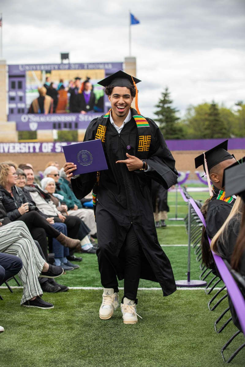Xaviar Thurman celebrates during the 2022 Undergraduate Commencement Ceremony for the Morrison Family College of Health, the School of Education and the School of Engineering on May 21, 2022, in St. Paul.